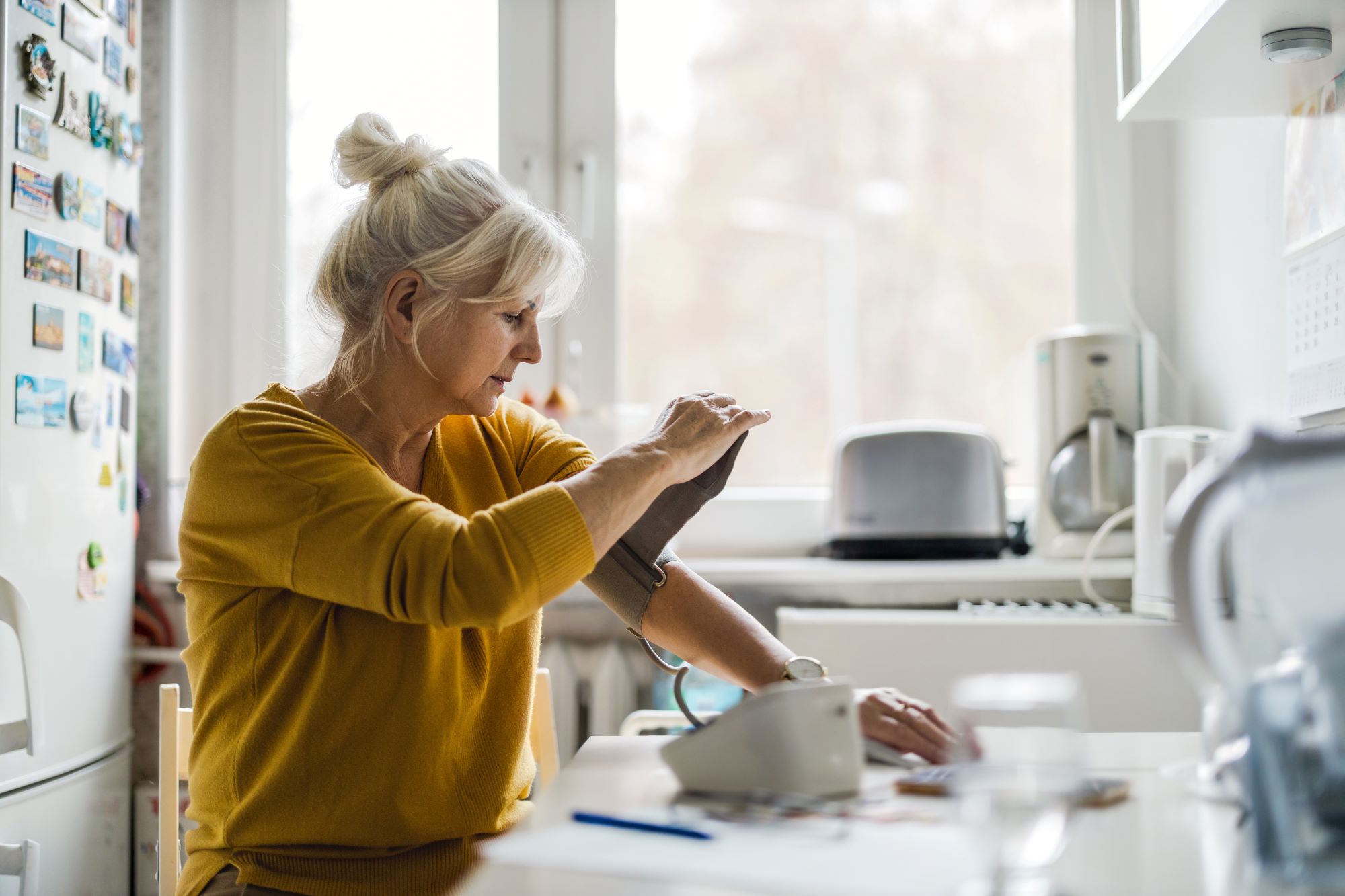 A picture of a woman checking her blood pressure