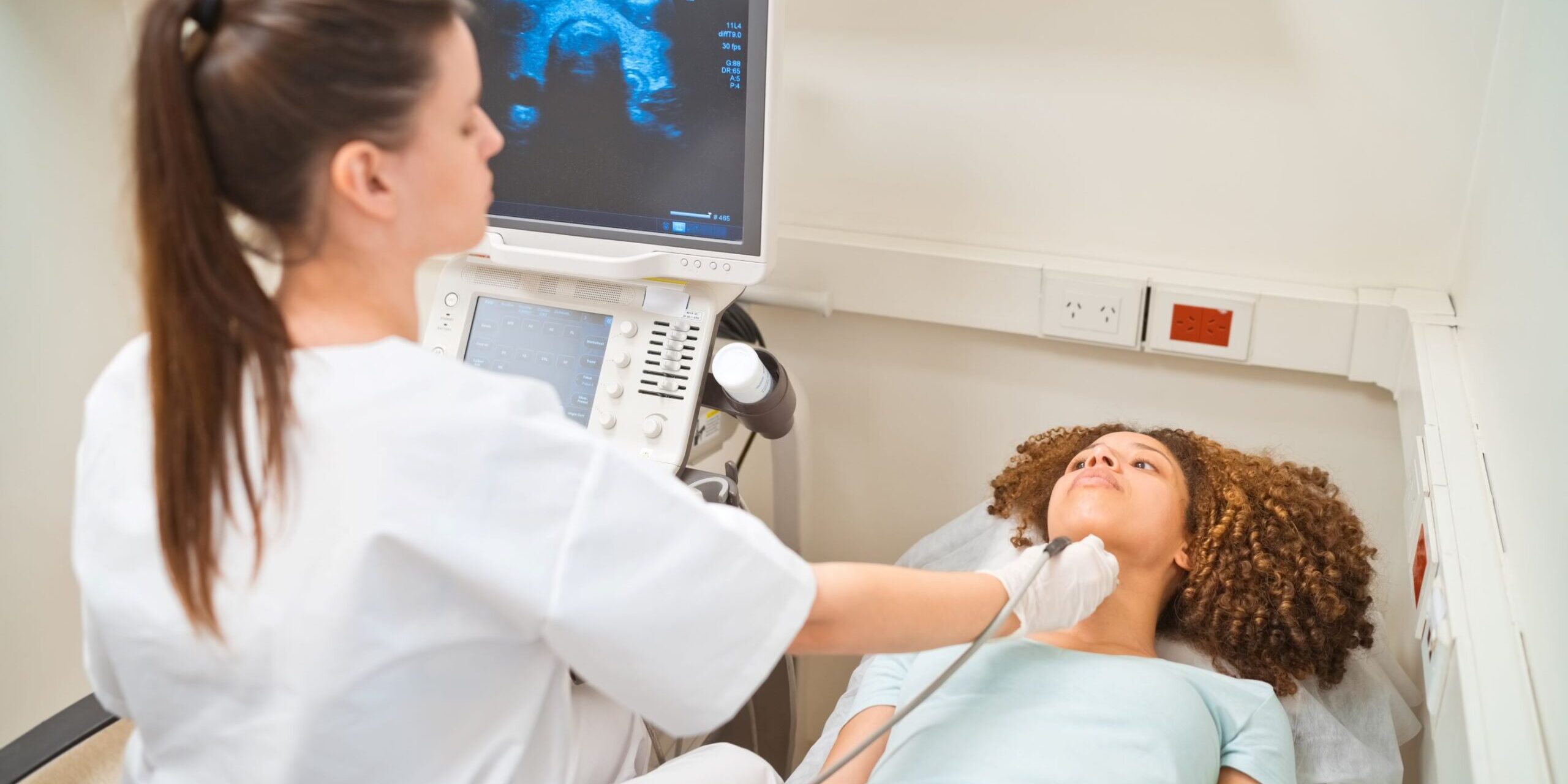 A girl getting her thyroid checked